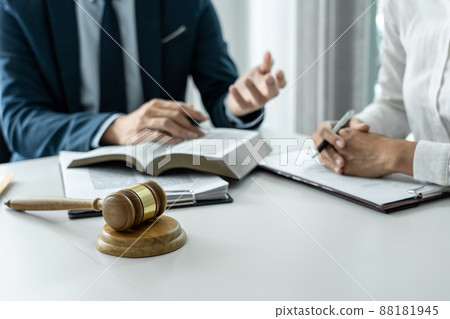 Male lawyer and professional businesswoman working and discussion having at law firm in office, Judge gavel with scales of justice 88181945