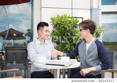 Businessman shaking hands to seal a deal with his partner 88185317