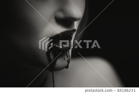 Woman with bloody mouth closeup photo Woman with bloody mouth closeup photo 88186231