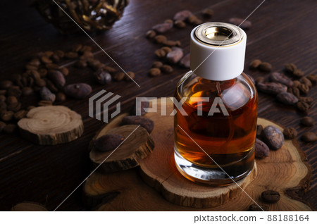 perfume bottles around ingredients on juniper wooden. perfume bottles around ingredients on juniper wooden. 88188164