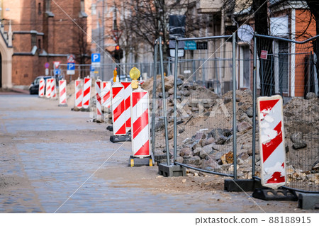 Road works in the city, oldtown. Stack with cobblestone, paving. Selective focus Road works in the city, oldtown. Stack with cobblestone, paving. Selective focus 88188915