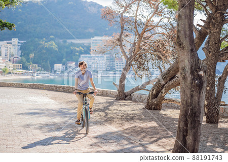 Man tourist on a bicycle explores Budva in Montenegro. Cycling in Montenegro concept 88191743