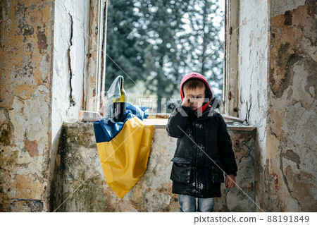 Little Boy in a Ruined House War in Ukraine Ukrainian flag Little Boy in a Ruined House War in Ukraine Ukrainian flag 88191849