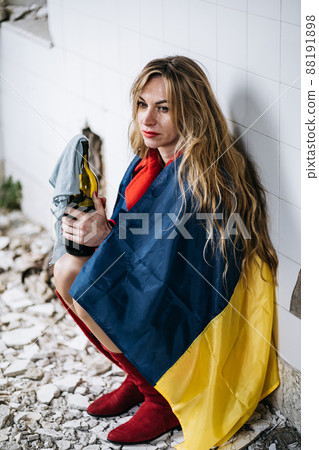 A Ukrainian woman in a ruined house. Flag of Ukraine. Stop War A Ukrainian woman in a ruined house. Flag of Ukraine. Stop War 88191898
