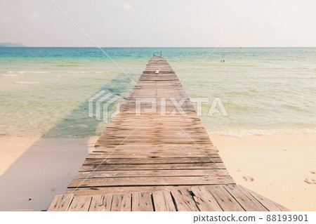 Scenic view of a wooden boardwalk leaving to the white sandy beach of Koh Rong Samloen Island, a popular summer getaway destination in Cambodia Scenic view of a wooden boardwalk leaving to the white sandy beach of Koh Rong Samloen Island, a popular summer getaway destination in Cambodia 88193901