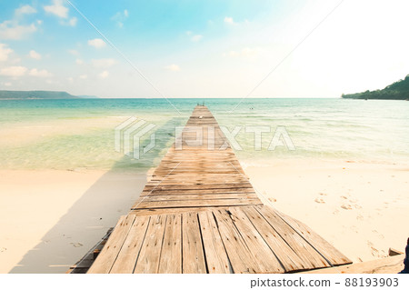 Scenic view of a wooden boardwalk leaving to the white sandy beach of Koh Rong Samloen Island, a popular summer getaway destination in Cambodia 88193903