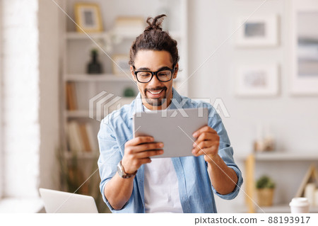Smiling black freelancer working on tablet at home 88193917