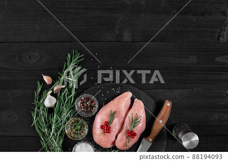 Raw chicken fillet with cooking ingredients on black slate table. Food background. Top view, copy space. Raw chicken fillet with cooking ingredients on black slate table. Food background. Top view, copy space. 88194093