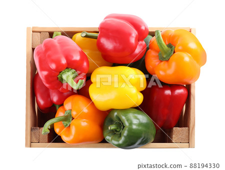 Wooden crate full of fresh ripe colorful bell peppers isolated on white, top view 88194330