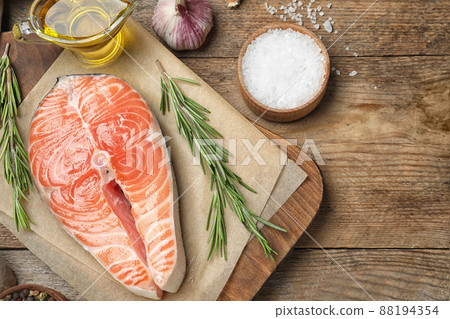 Flat lay composition with fresh raw salmon and products on wooden table. Fish delicacy 88194354