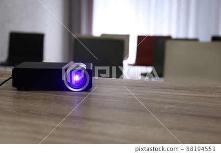Modern video projector on wooden table in conference room. Space for text Modern video projector on wooden table in conference room. Space for text 88194551