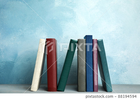 Collection of old books on grey wooden shelf Collection of old books on grey wooden shelf 88194594