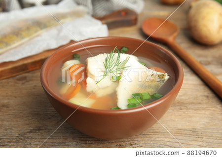 Delicious fish soup in bowl on wooden table Delicious fish soup in bowl on wooden table 88194670