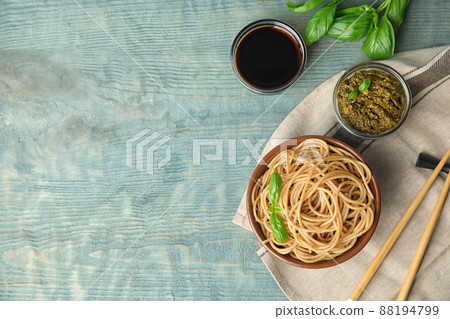 Tasty buckwheat noodles served on blue wooden table, flat lay. Space for text Tasty buckwheat noodles served on blue wooden table, flat lay. Space for text 88194799