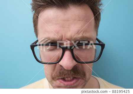 Caucasian man with mustache shouting being angry and furious. 88195425