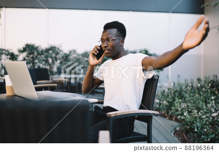 Stressed dark skinned businessman discussing online project issues on distance job Stressed dark skinned businessman discussing online project issues on distance job 88196364