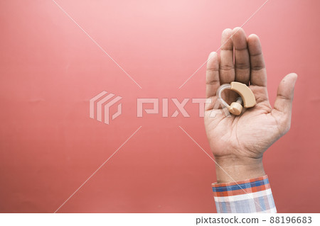 Hearing aid concept, a young man with hearing problems. 88196683