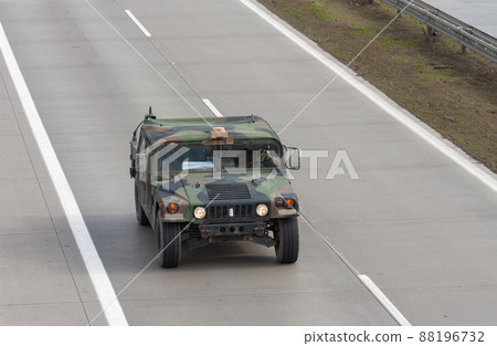 Humvee, high mobility multipurpose wheeled vehicle drives on highway . 88196732