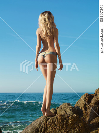 Summer portrait of a young model relaxing by the sea. 88197343