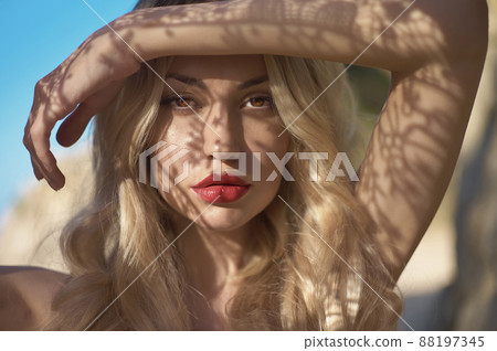 Portrait of a model with a pattern on her face. 88197345