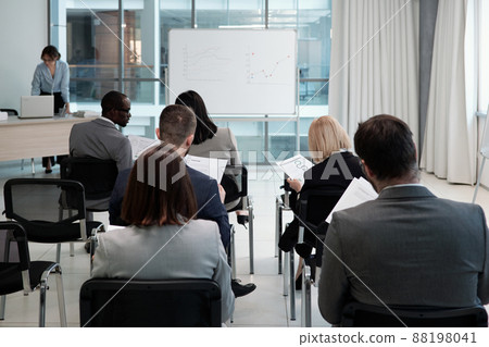 Group of contemporary economists analyzing financial documents with data 88198041