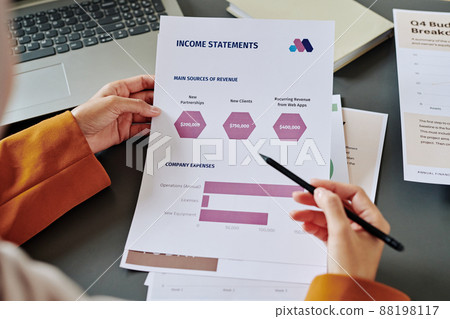 Hands of young female accountant pointing at document with chart and diagrams Hands of young female accountant pointing at document with chart and diagrams 88198117