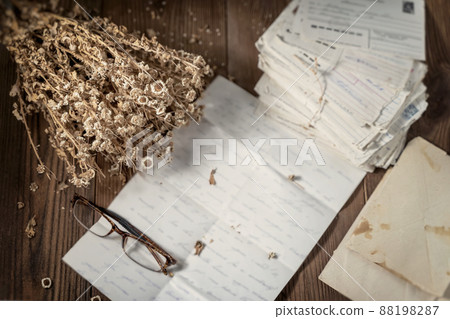 Old letters, eyeglasses and dried flowers. Vintage, sepia. Nostalgic Reading Old letters, eyeglasses and dried flowers. Vintage, sepia. Nostalgic Reading 88198287