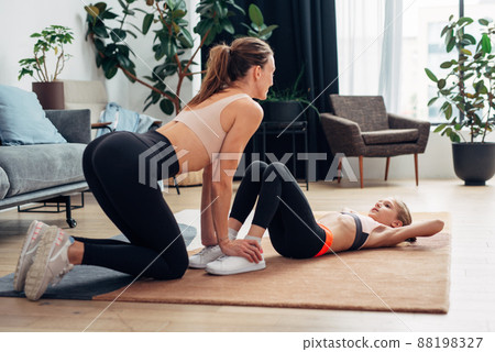 Girl doing sit-ups with her mother Workout at home Girl doing sit-ups with her mother Workout at home 88198327