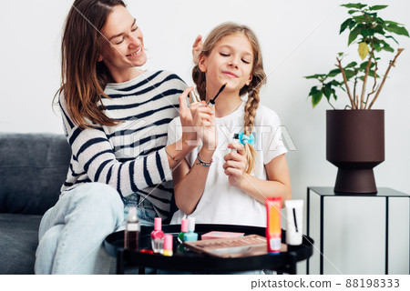 Mother and daughter wearing perfume Mother and daughter wearing perfume 88198333