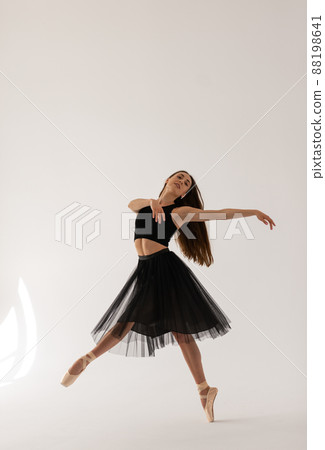 Beautiful ballerina dancing at studio in black dress, have training. Beautiful ballerina dancing at studio in black dress, have training. 88198641