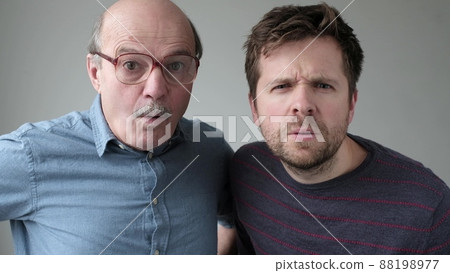 Surprised two men have scared expressions can not believe their eyes. Surprised two men have scared expressions can not believe their eyes. 88198977