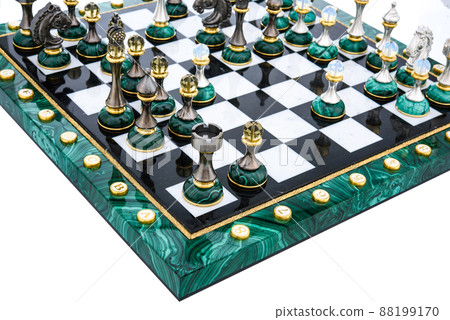 Malachite stone chess pieces on and marble chessboard 88199170