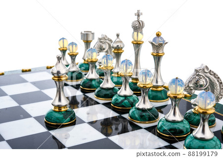 Malachite stone chess pieces on and marble chessboard Malachite stone chess pieces on and marble chessboard 88199179