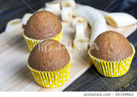 delicious wheat cupcakes on a black wooden table delicious wheat cupcakes on a black wooden table 88199662