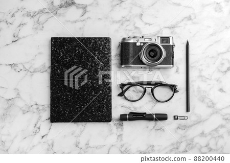 Flat lay composition with camera for professional photographer and accessories on white marble table Flat lay composition with camera for professional photographer and accessories on white marble table 88200440