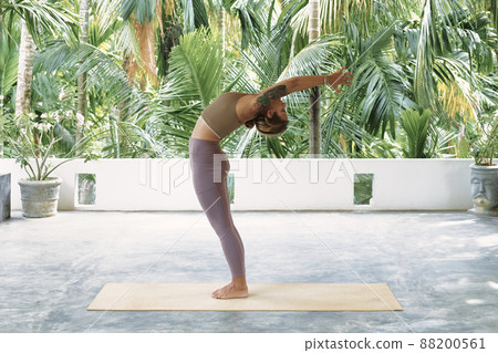 Woman Practicing Advanced Yoga on Organic Mat. Series of Yoga Poses. Tropical background 88200561