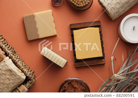 Handmade soap surrounded by bathroom accessories. Cozy home textiles and body care with organic products. 88200591