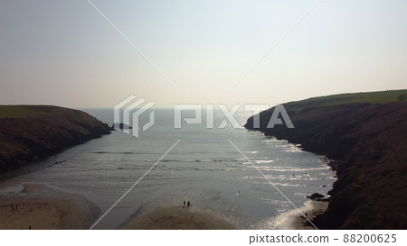 aerial drone flight over Stradbally Cove, Atlantic Ocean beach on the Cooper Coast, Waterford, Ireland. aerial drone flight over Stradbally Cove, Atlantic Ocean beach on the Cooper Coast, Waterford, Ireland. 88200625