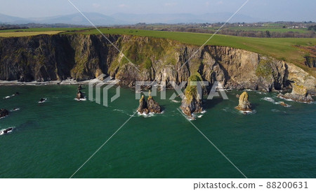 huge rocks and cliffs in the middle of the Atlantic Ocean in a UNESCO protected geopark, Stradbally Cove, on the Cooper Coast, Waterford, Ireland. huge rocks and cliffs in the middle of the Atlantic Ocean in a UNESCO protected geopark, Stradbally Cove, on the Cooper Coast, Waterford, Ireland. 88200631