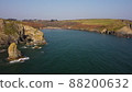 sideways movement of drone over the Atlantic Ocean. flying over cliffs and a blue sea. Stradbally Cove, Cooper Coast, Waterford, Ireland. 88200632