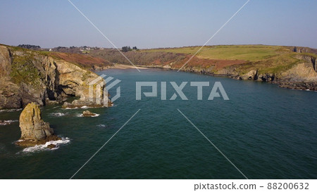 sideways movement of drone over the Atlantic Ocean. flying over cliffs and a blue sea. Stradbally Cove, Cooper Coast, Waterford, Ireland. 88200632