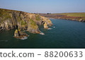 drone over the Atlantic Ocean. flying over cliffs and a blue sea. Stradbally Cove, Cooper Coast, Waterford, Ireland. 88200633