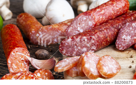 sliced pieces of sausage from meat are lying on a cutting board sliced pieces of sausage from meat are lying on a cutting board 88200873