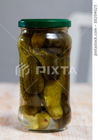 Glass jar of pickled cucumbers Glass jar of pickled cucumbers 88204025