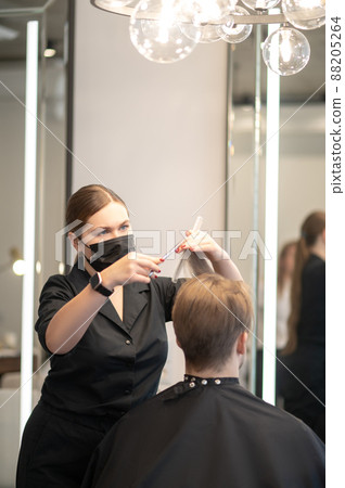 Long-haired hairdresser working with a male client at the beauty slaon 88205264