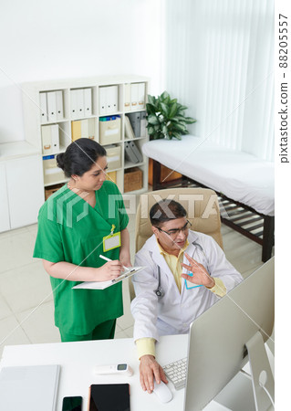 Doctors Discussing Medical Case 88205557