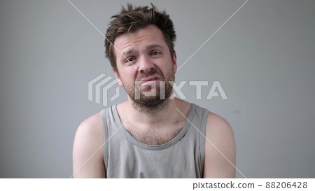 Sad young man looking at camera is about to cry. 88206428