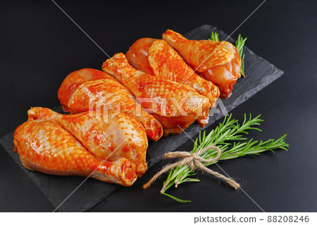 Convenience food, precooked.Raw Marinated chicken meat legs with spices for cooking for BBQ dark background. Top view.Copy space. Convenience food, precooked.Raw Marinated chicken meat legs with spices for cooking for BBQ dark background. Top view.Copy space. 88208246