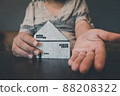 Housing Loan and Real Estate Broker Selling Agency Concept. Business Woman Hands Offer House Model to Customer for Sale,Rent. Business House Realty Agent and Residential Investment. 88208322