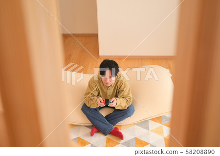 Man playing games at home Man playing games at home 88208890